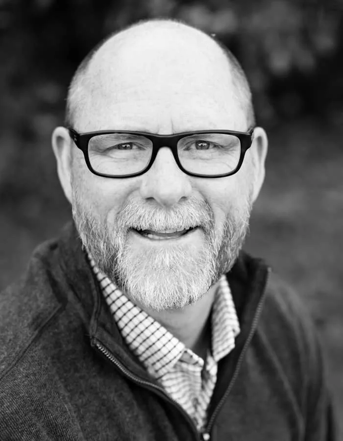 Man with Glasses Smiling Car Dealer Team Member